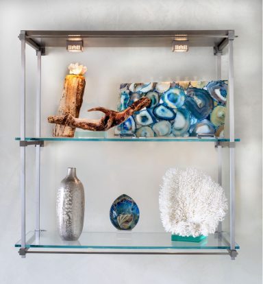 Modern shelves displaying decorative items, including coral, agate, and metallic accents.