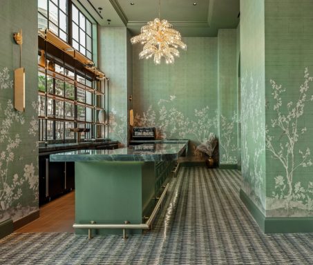 Elegant green interior with botanical wall art and a sleek countertop.