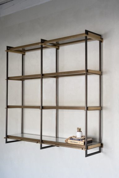 Milano Series wall-mounted shelving crafted from custom bronze extrusions with integrated lighting.